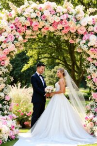 Elegant Wedding Ceremony Under Blooming Arch – free AI stock image