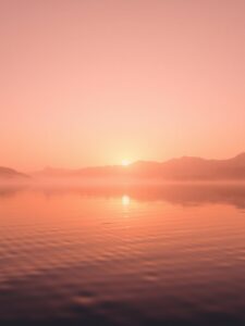 Hazy Sunrise Over a Tranquil Lake – free AI stock image