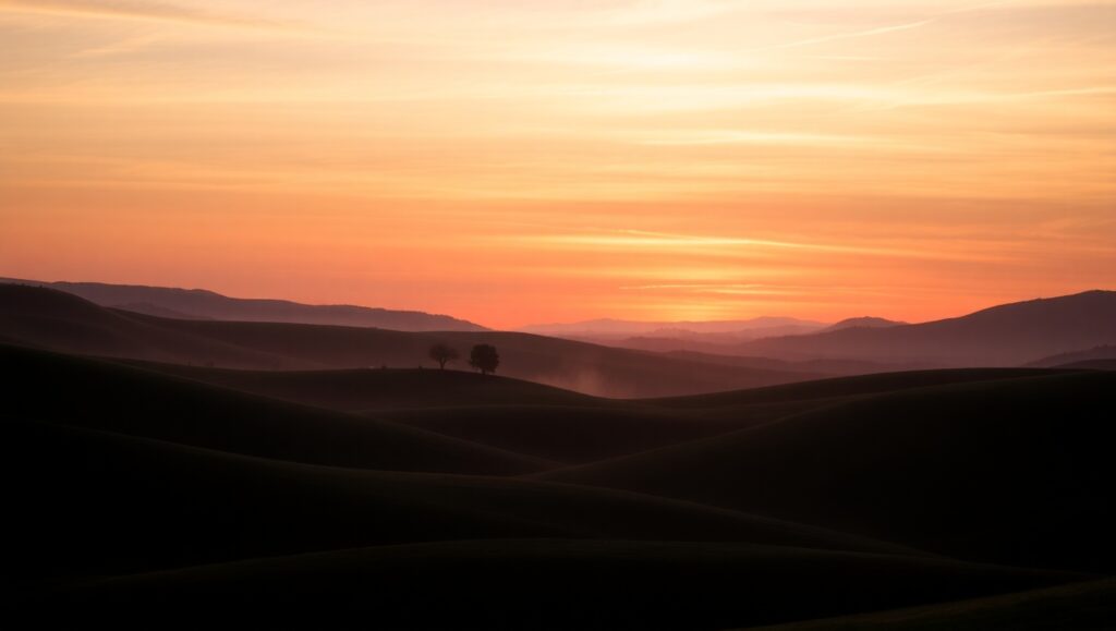 Serene Sunset Over Rolling Hills – free AI stock image