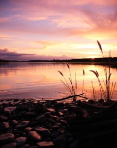 Sunset Over a Tranquil Lake with Objects – free AI stock image