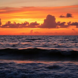 Tranquil Blue Ocean Waves at Sunset – free AI stock image
