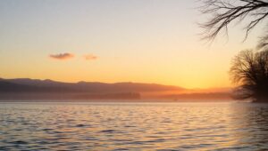 Tranquil Sunrise Over Calm Lake – free AI stock image