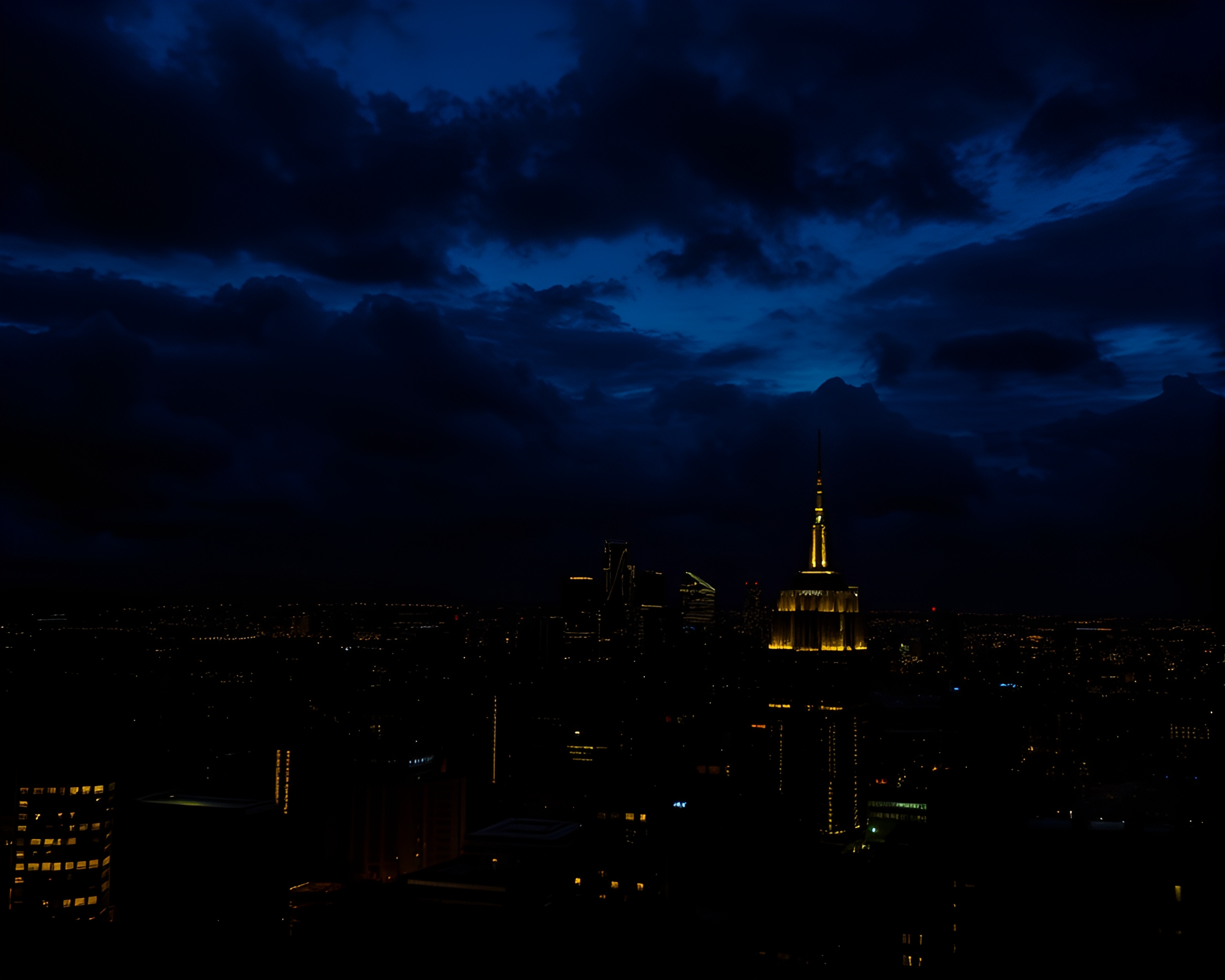 Eerie Urban Skyline Glowing Against Ominous Dusk Sky – free AI stock image