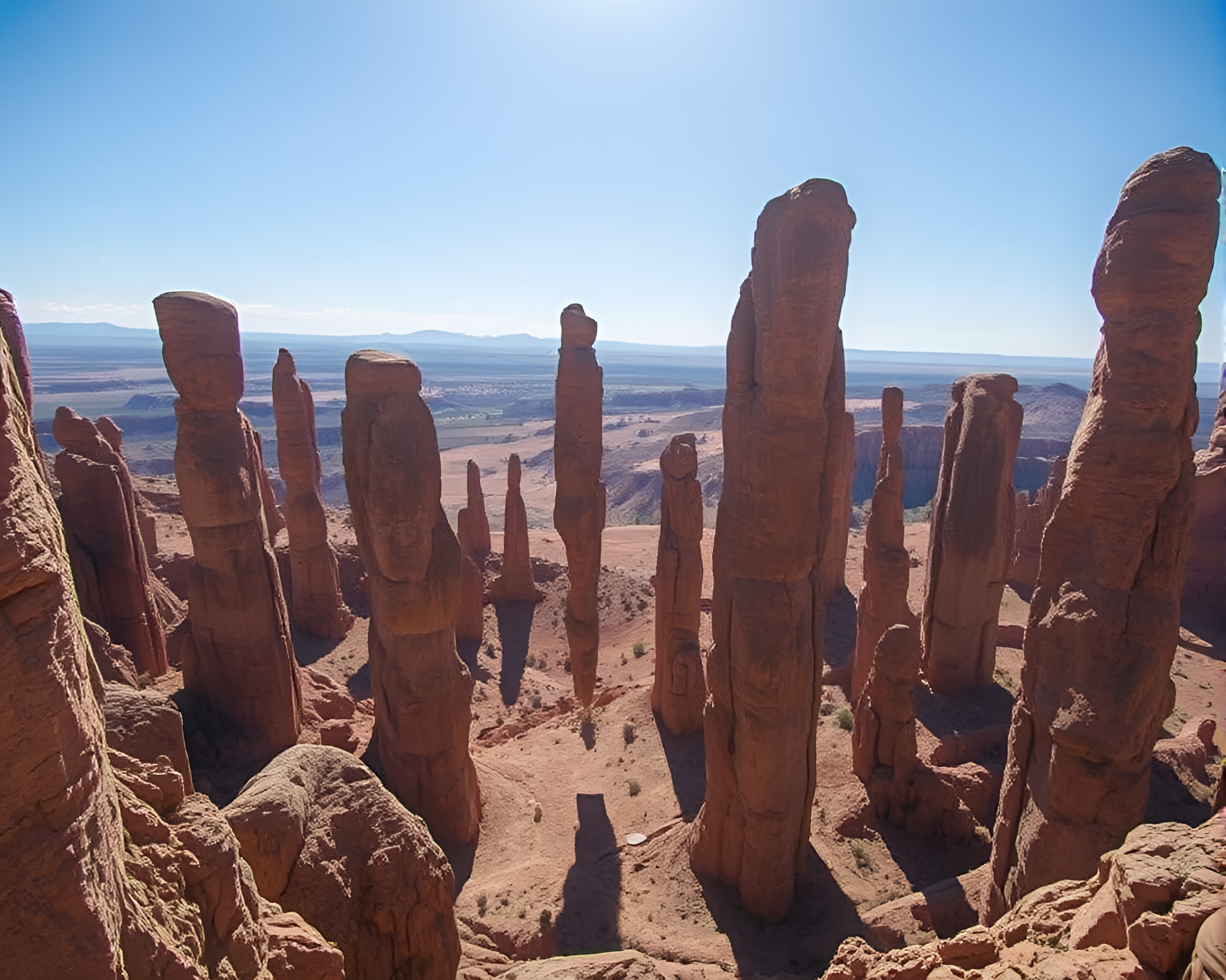 Monolithic Pillars Stand Tall in Desolate Landscape – free AI stock image