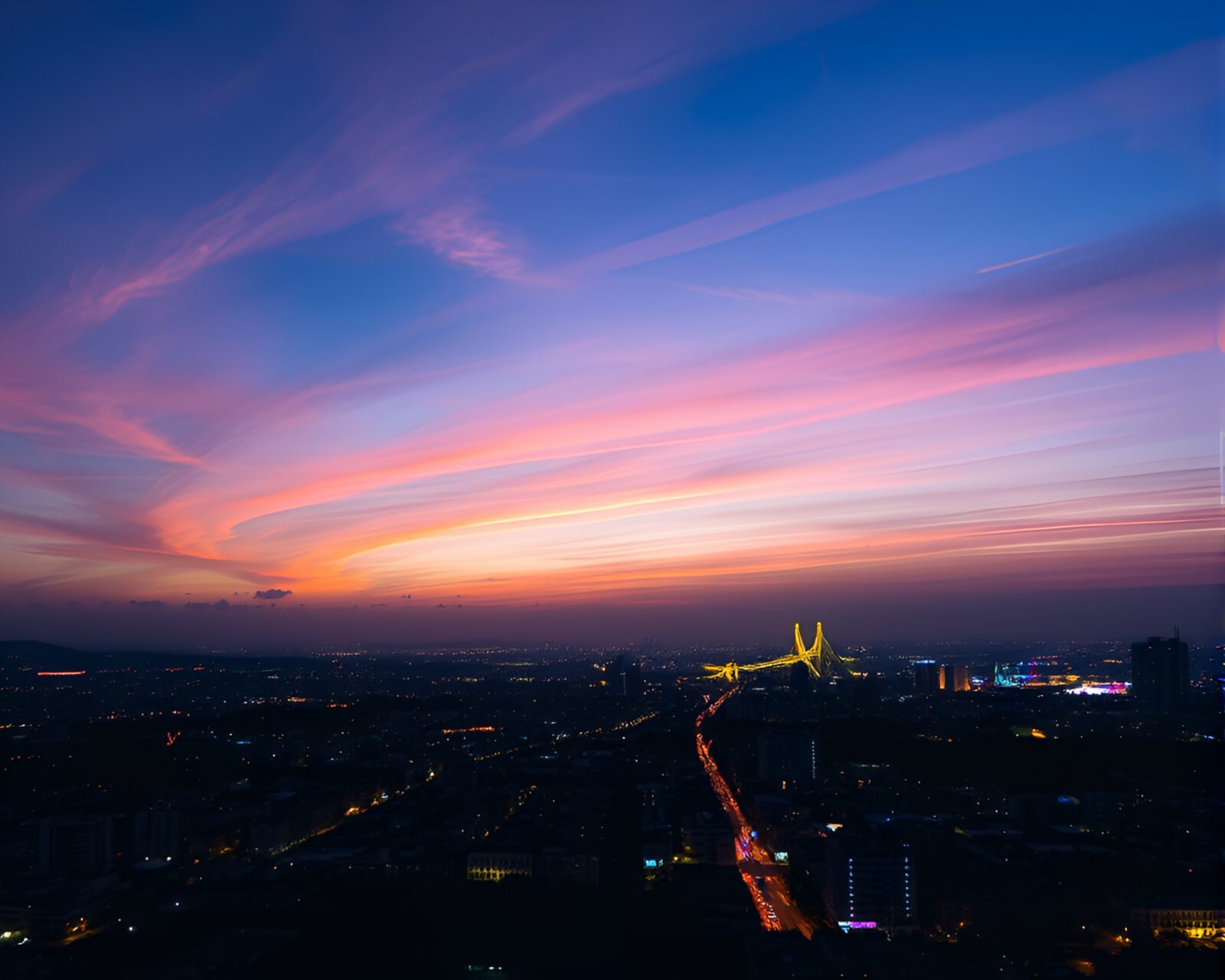 Ethereal pastel sky above bustling city with twinkling lights
