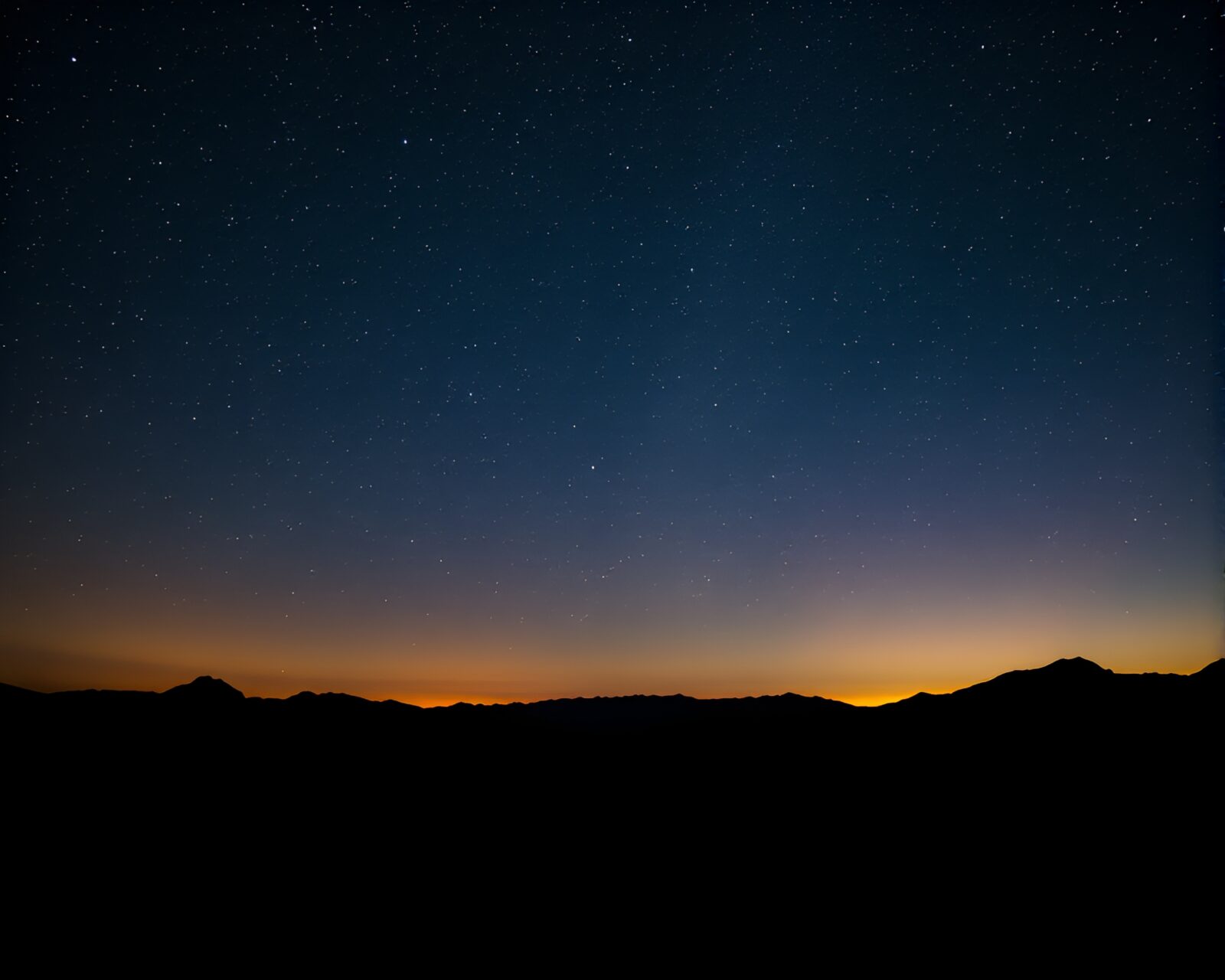 Spectacular view of starry night sky above majestic mountains