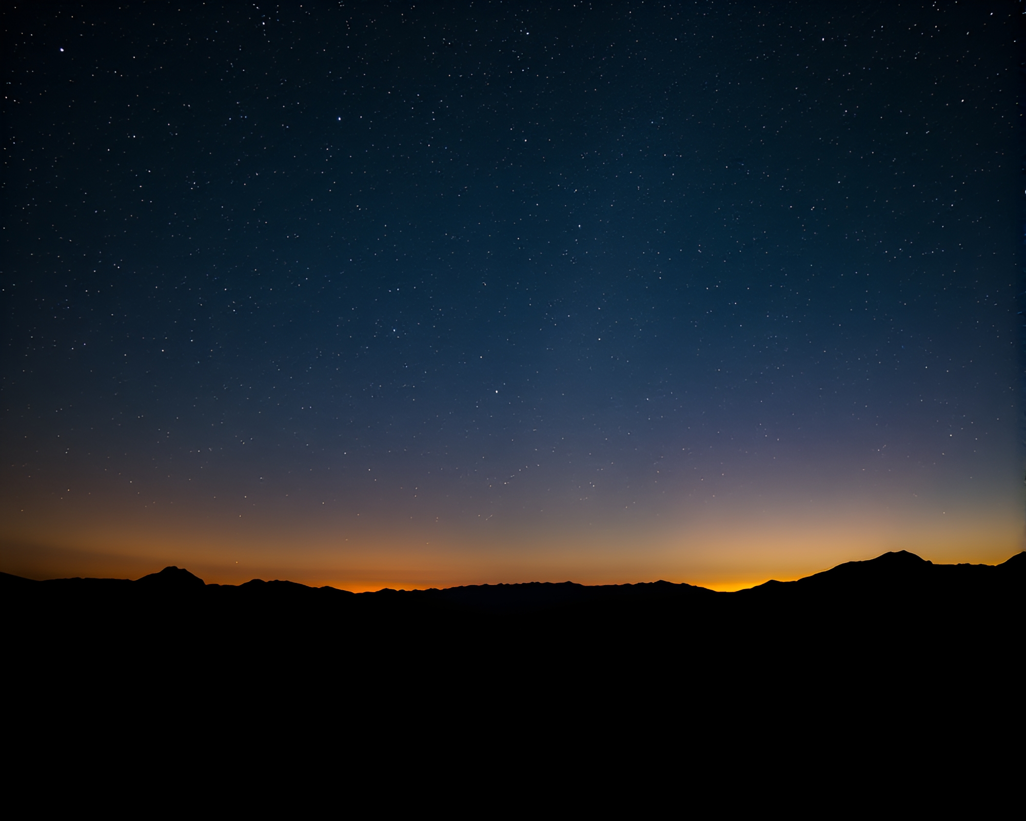 Starry Night Sky with Silhouetted Mountains – free AI stock image