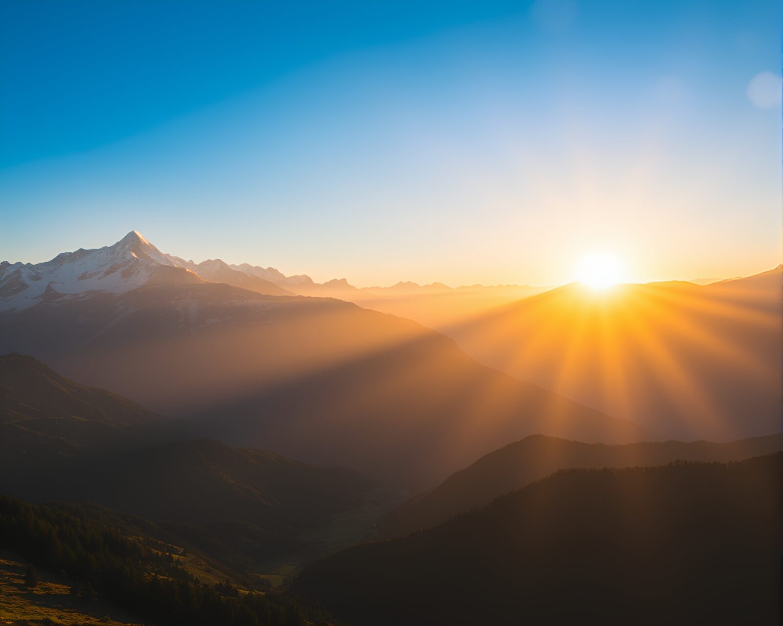 A majestic sunrise casting warm hues over snow-capped mountains