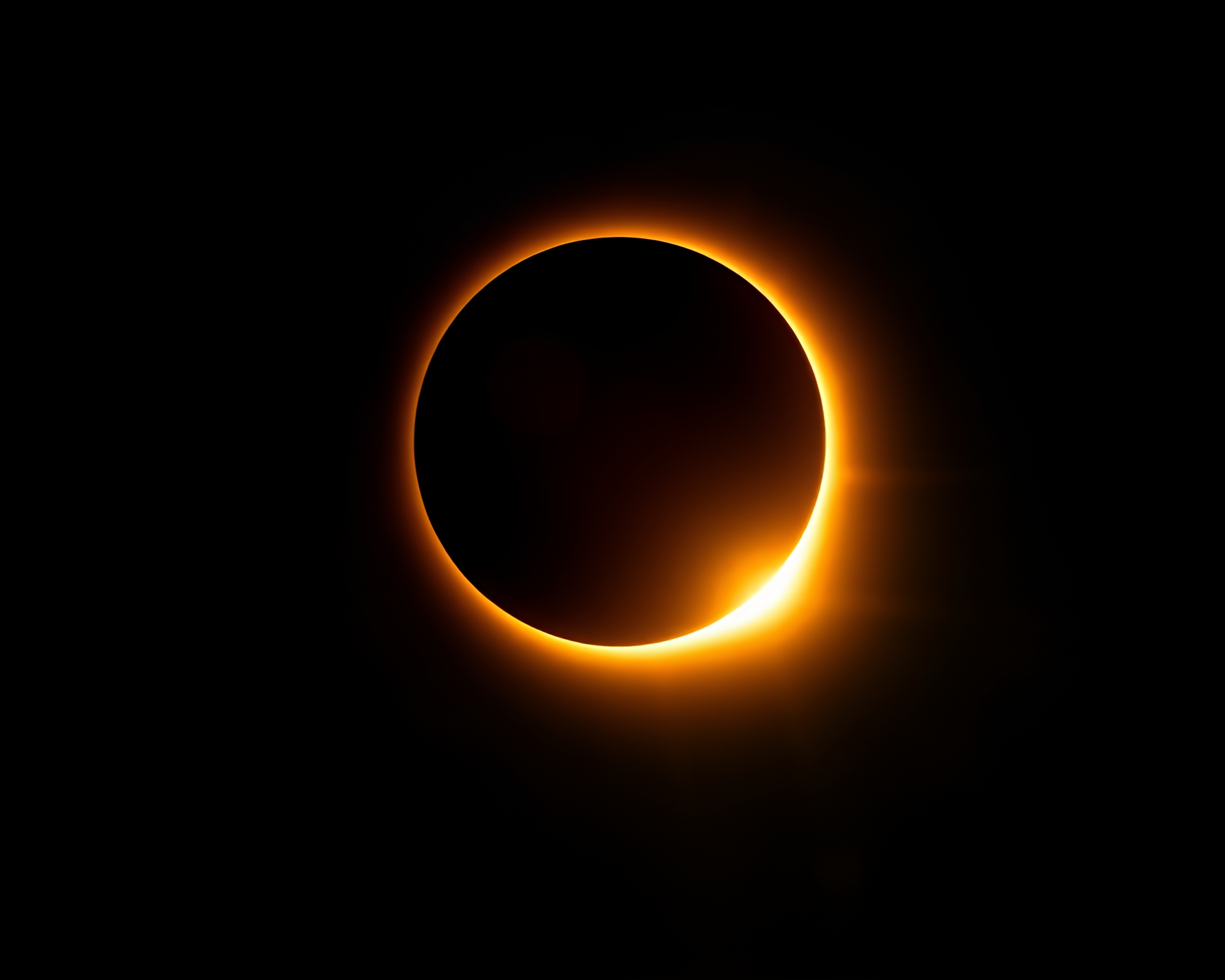 Ethereal Solar Eclipse Drifting Across Darkened Sky – free AI stock image
