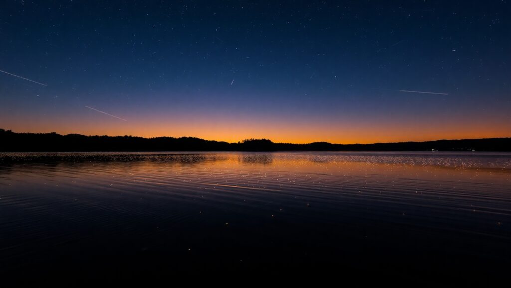 Fireflies Dancing Over a Calm Lake – free AI stock image