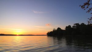 Serene Sunset Over Calm Lake – free AI stock image