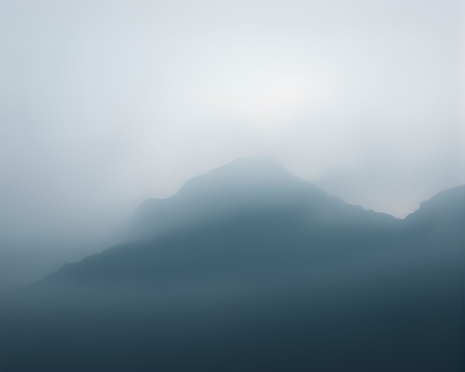 Minimalist mountains shrouded in mist with ambient lighting
