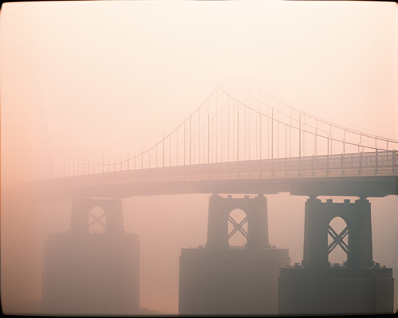 Dreamy haze surrounds a mystical bridge with film strip border