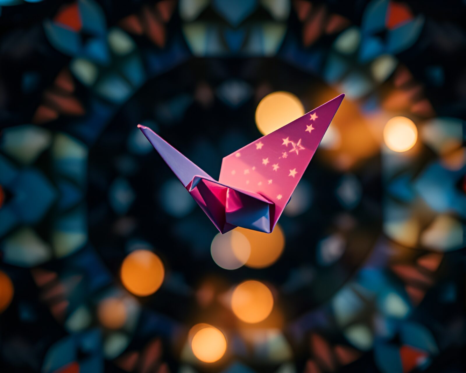 Colorful kaleidoscope patterns engulf a delicate origami crane