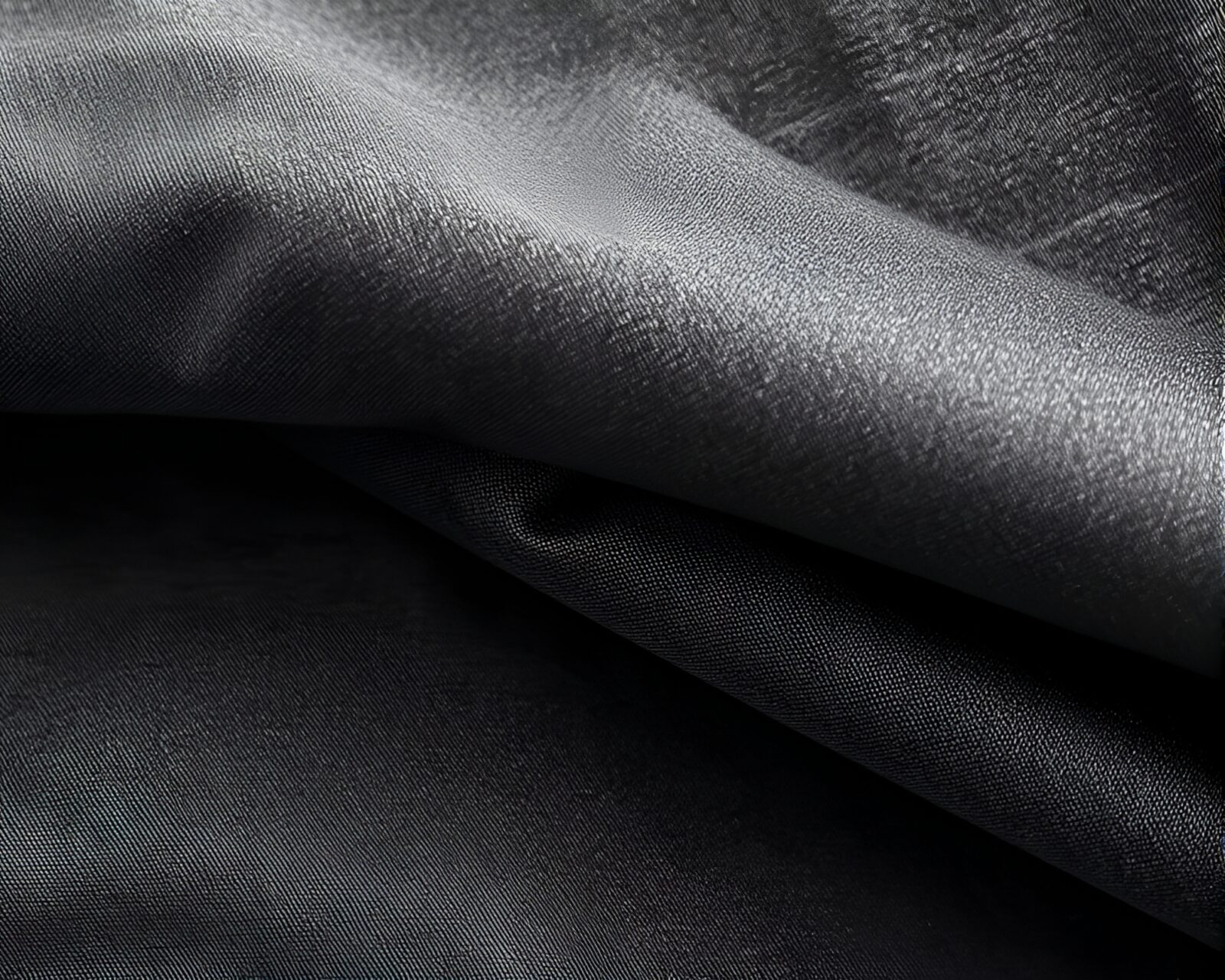 Llama sculpture surrounded by intricate fabric folds in gray hues