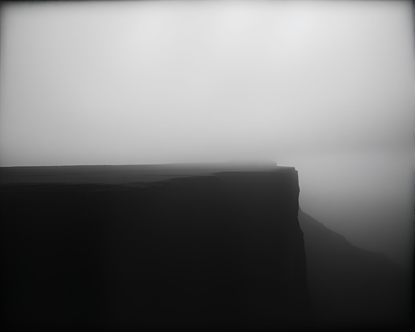 Desaturated stitching pattern on a bleak cliff in film noir style