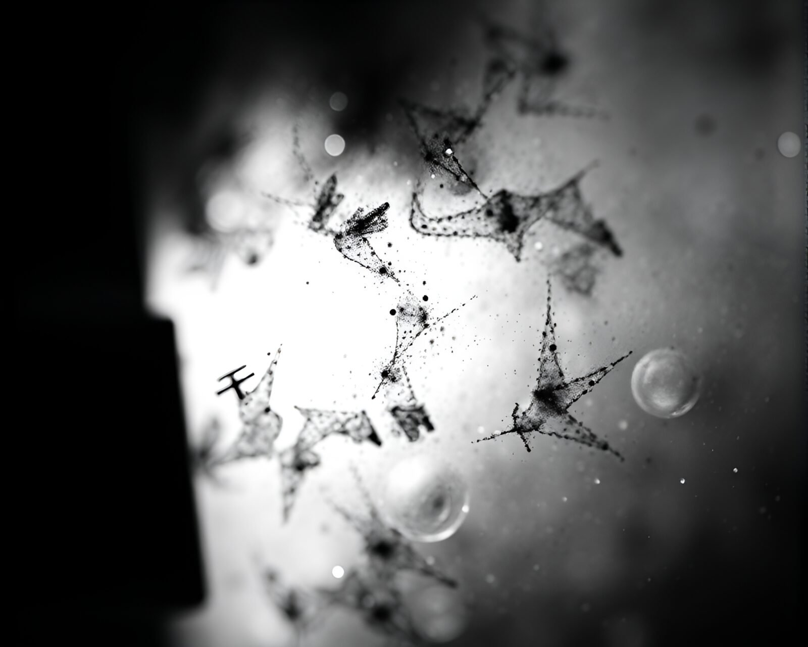 Silhouetted quantum computer parts with intricate details in ink wash