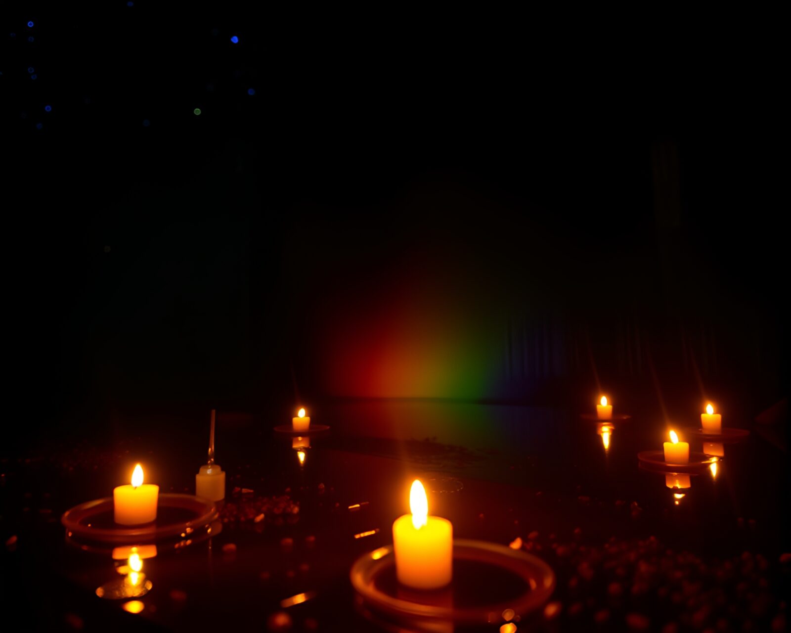 Candlelit ambiance highlights softbox-lit oil slick rainbow composition