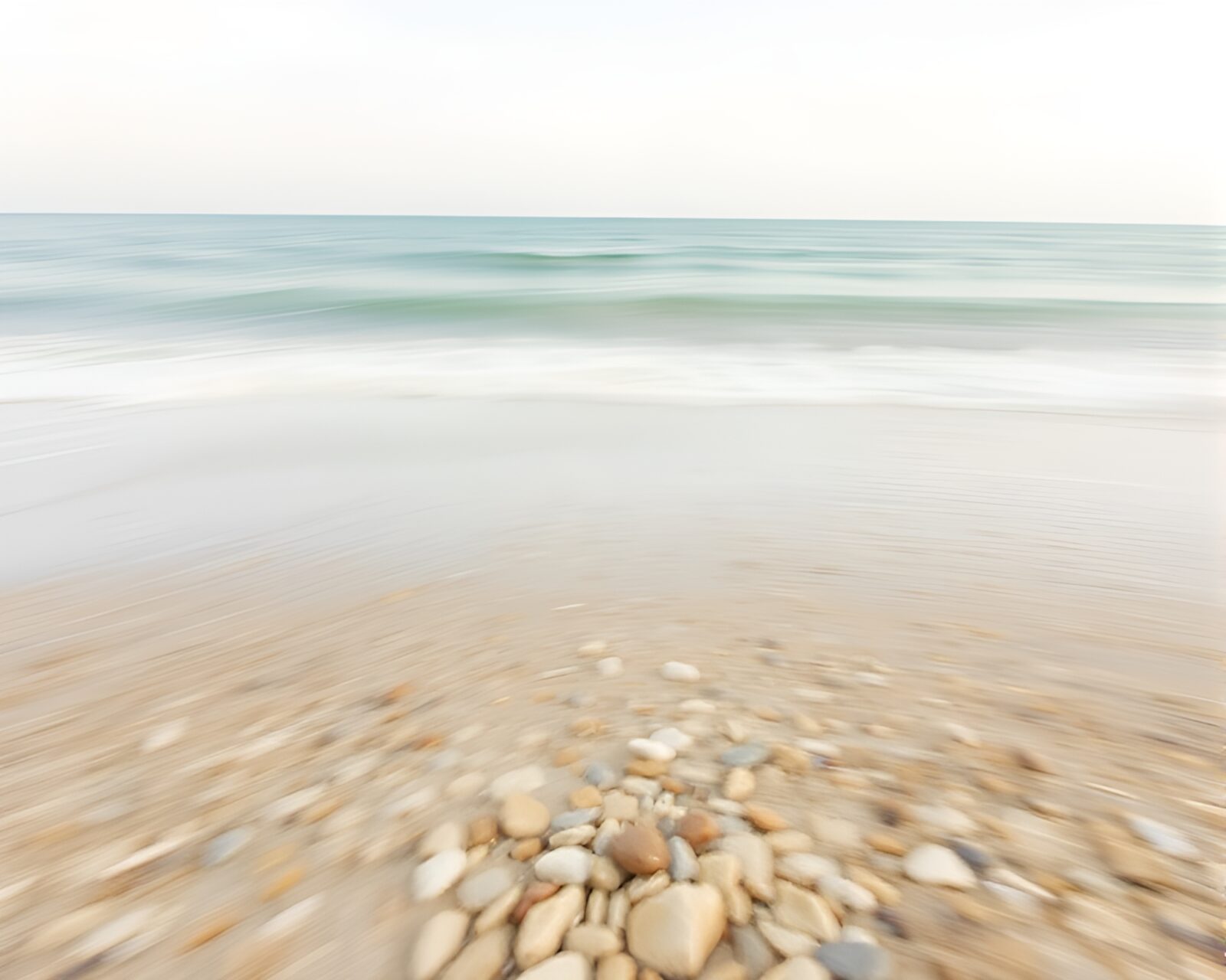 Serene off-white sunset on a beach with motion blur