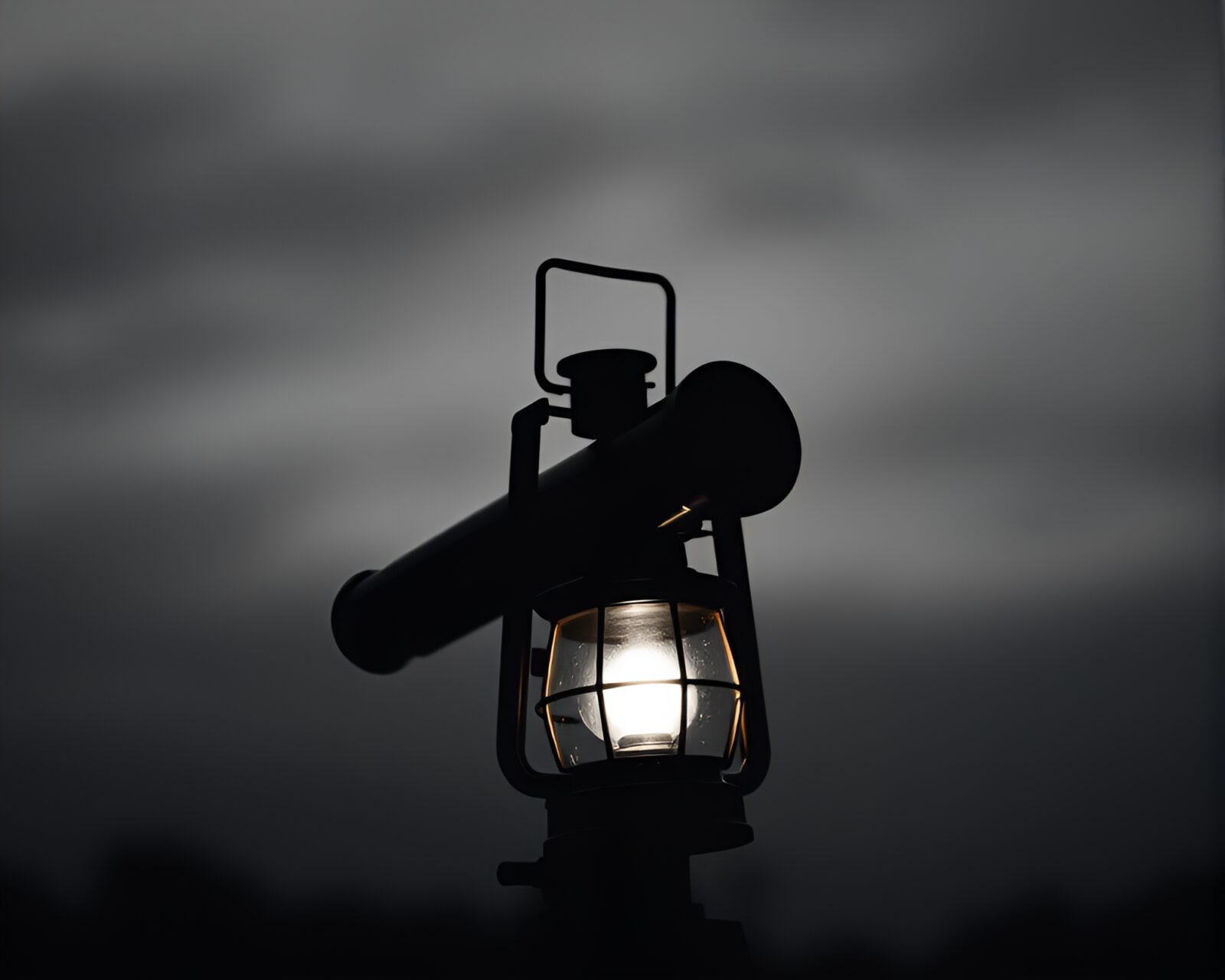 Black and white image of a telescope under glowing lantern