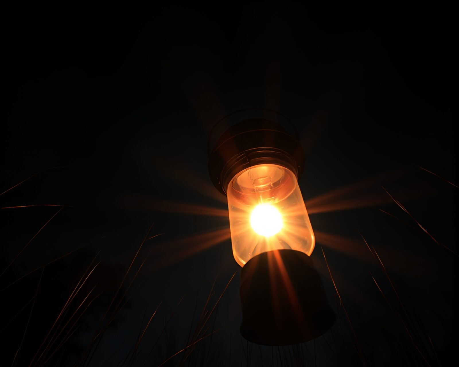 Worm's eye view of high-contrast oil lantern with solar flare glow