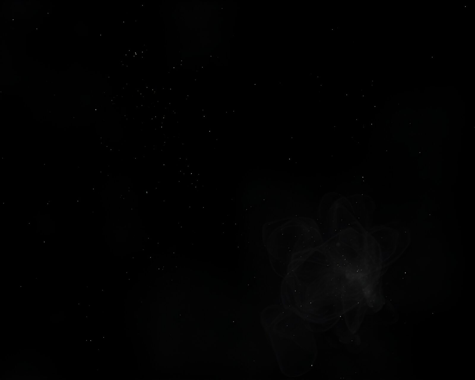 Futuristic quantum computer glowing in darkness with dust particles