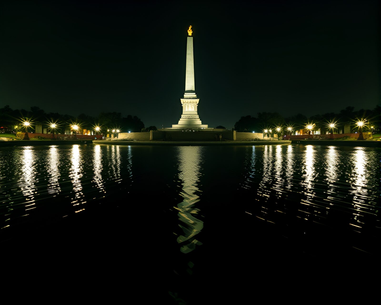 Double exposure statue reflected in rippling water with bright lighting