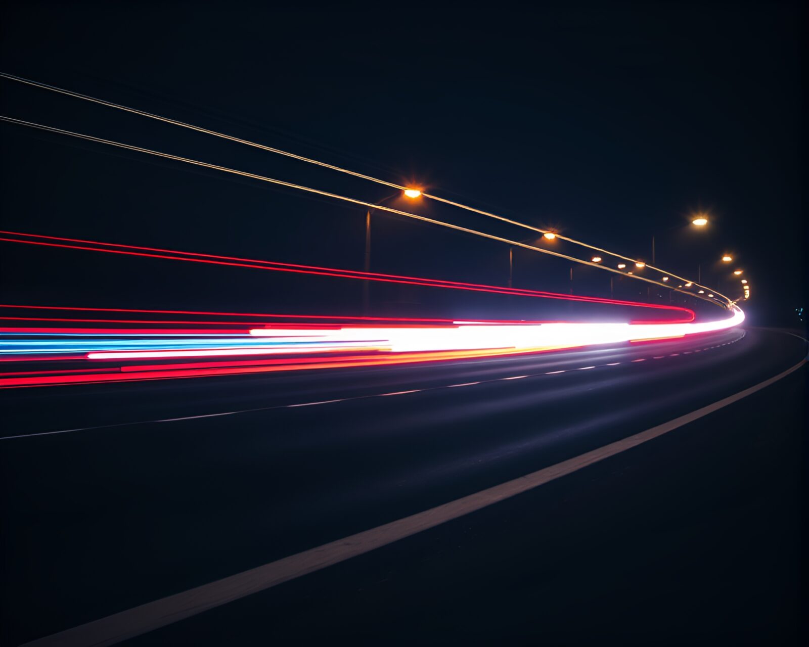 Long exposure photograph of swirling car lights at night