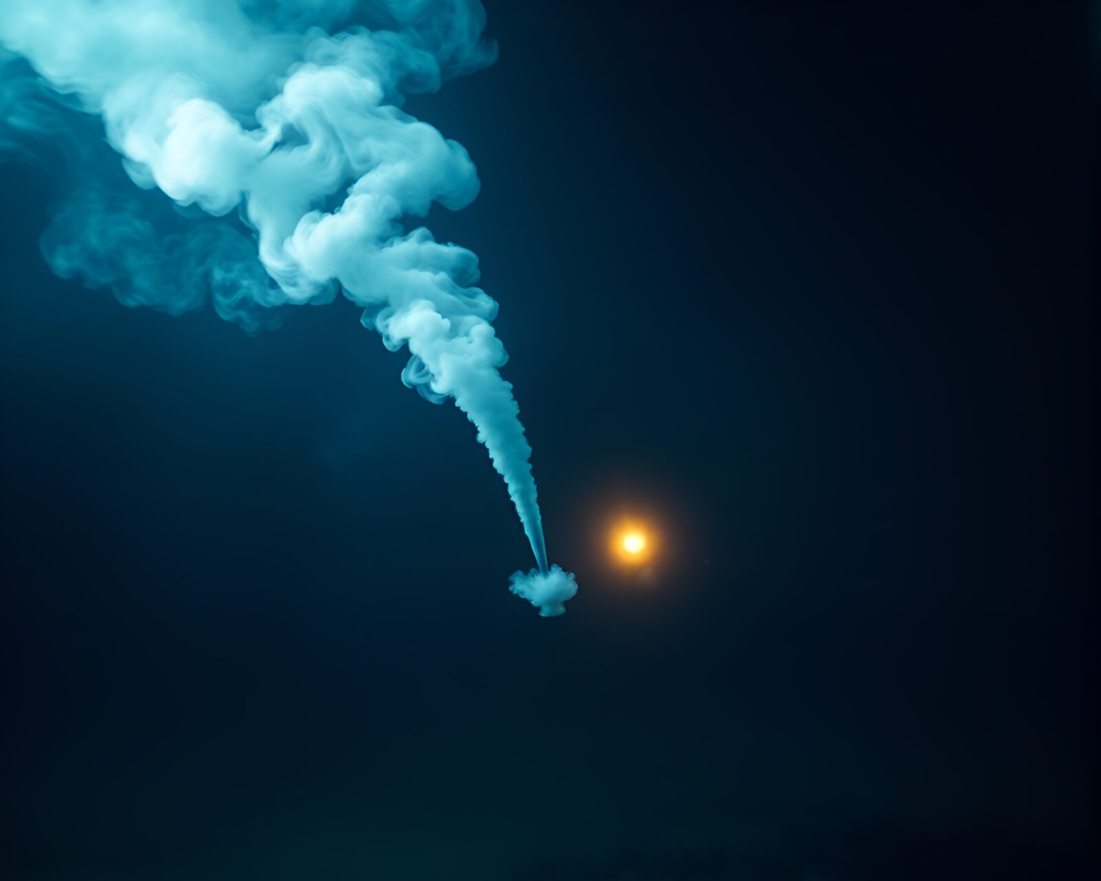 Mysterious smoke plume swirls around illuminated submarine