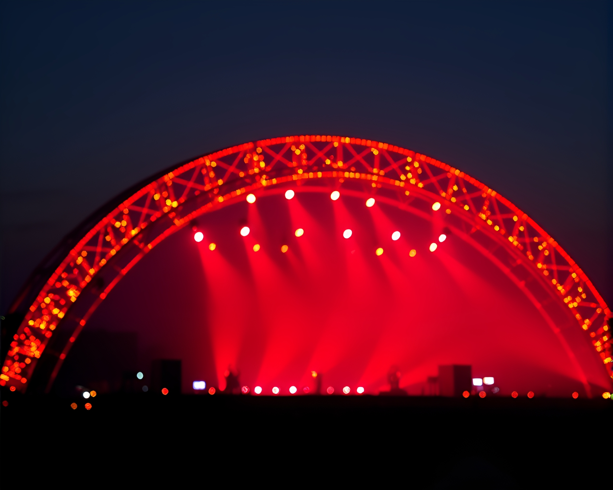 Dotted Arch Bridge Illuminated by Concert Lights – free AI stock image