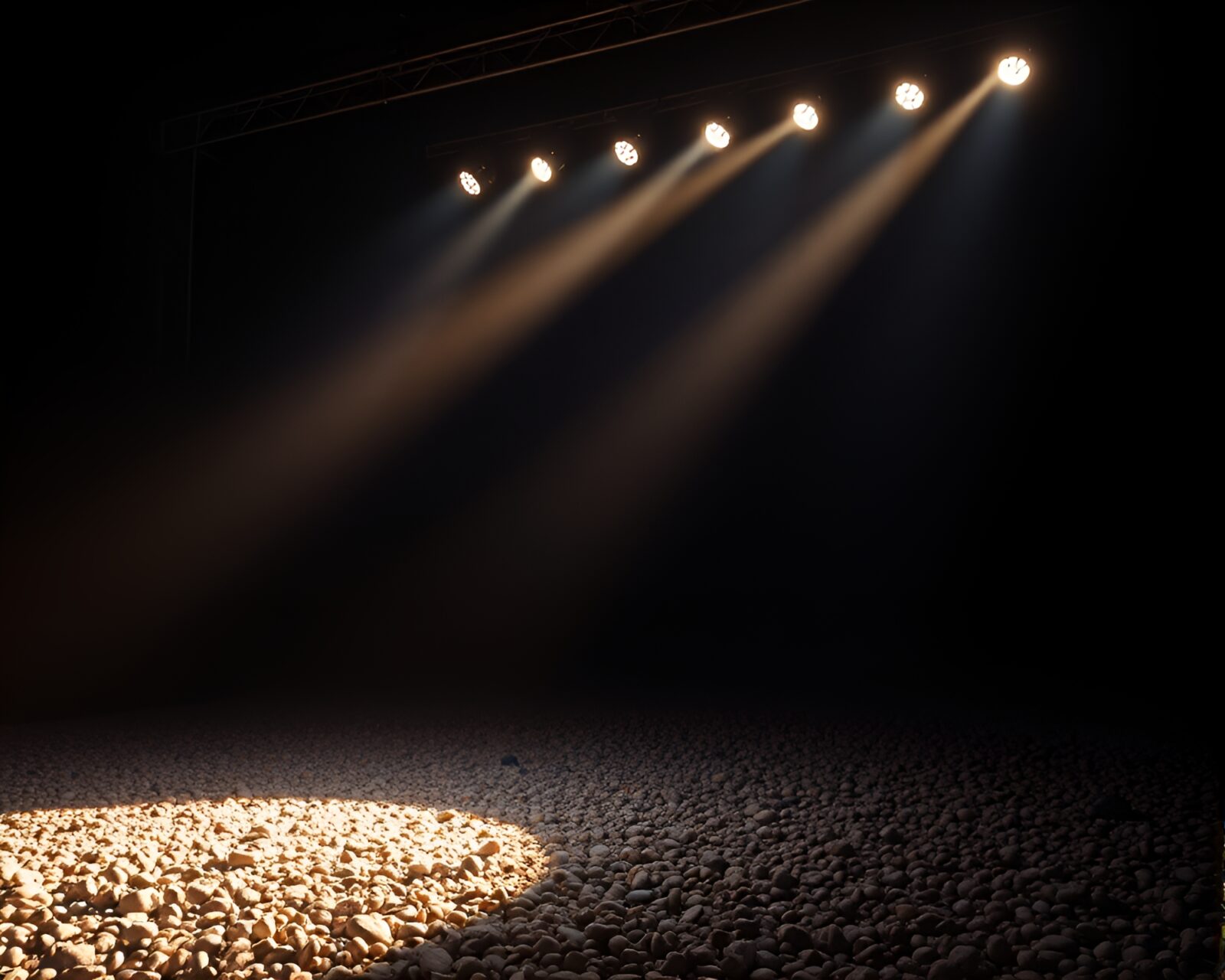 Low-angle view of pebbles under intense stage lighting