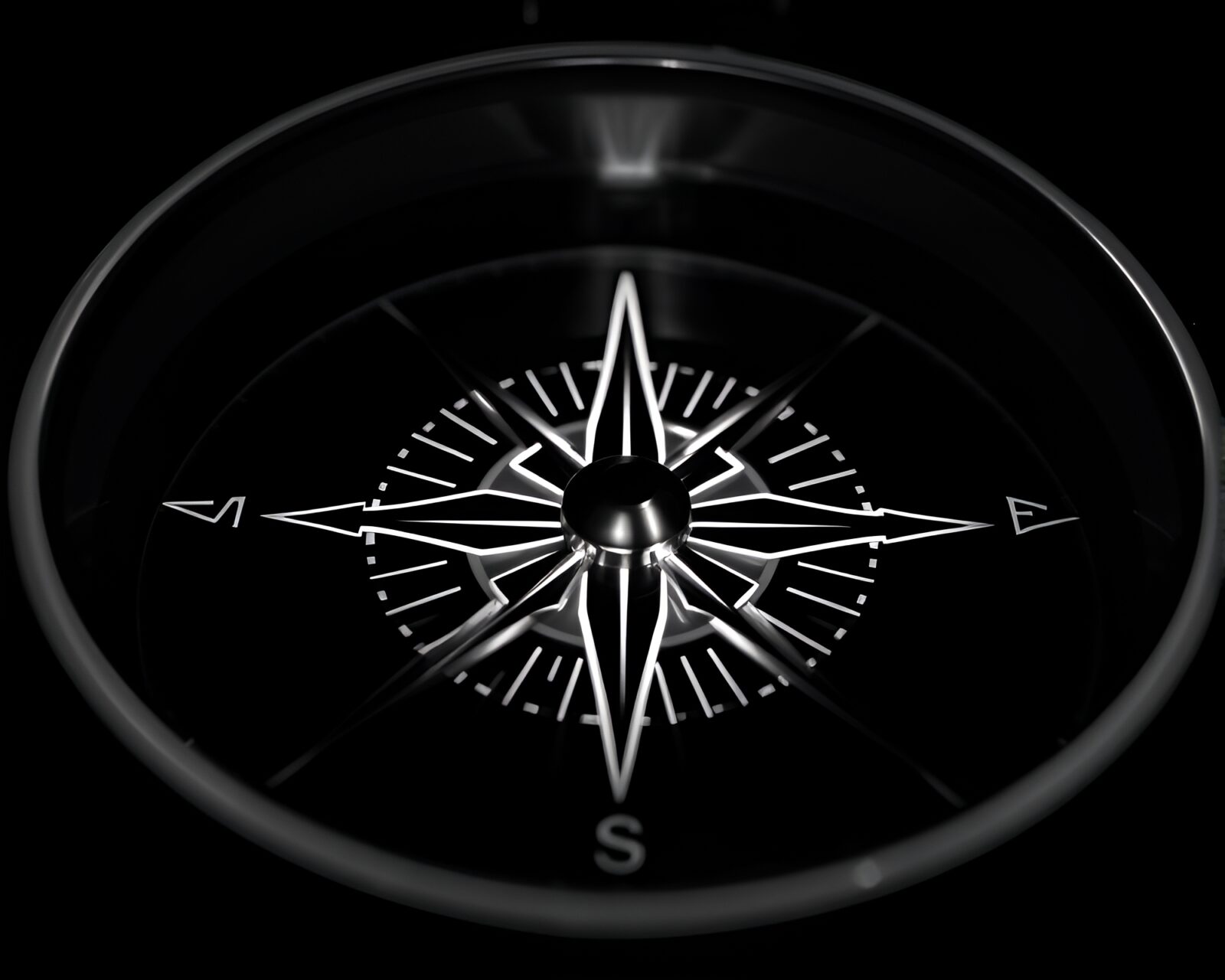 A glowing compass on dark background in black and white.
