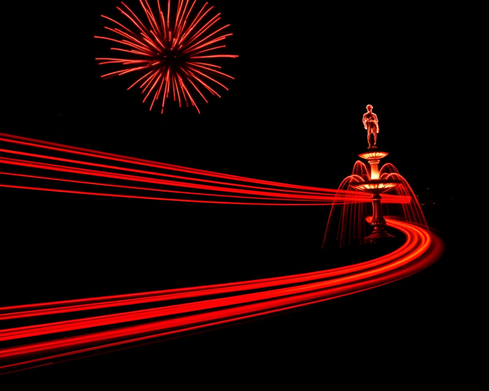 Vibrant ruby red car light trails around chocolate fountain