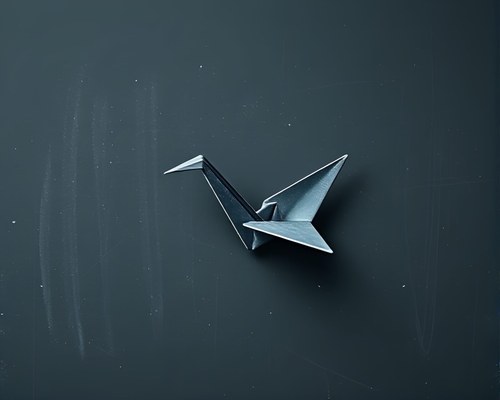 Elegant origami crane against smudged chalkboard, in graphite hues