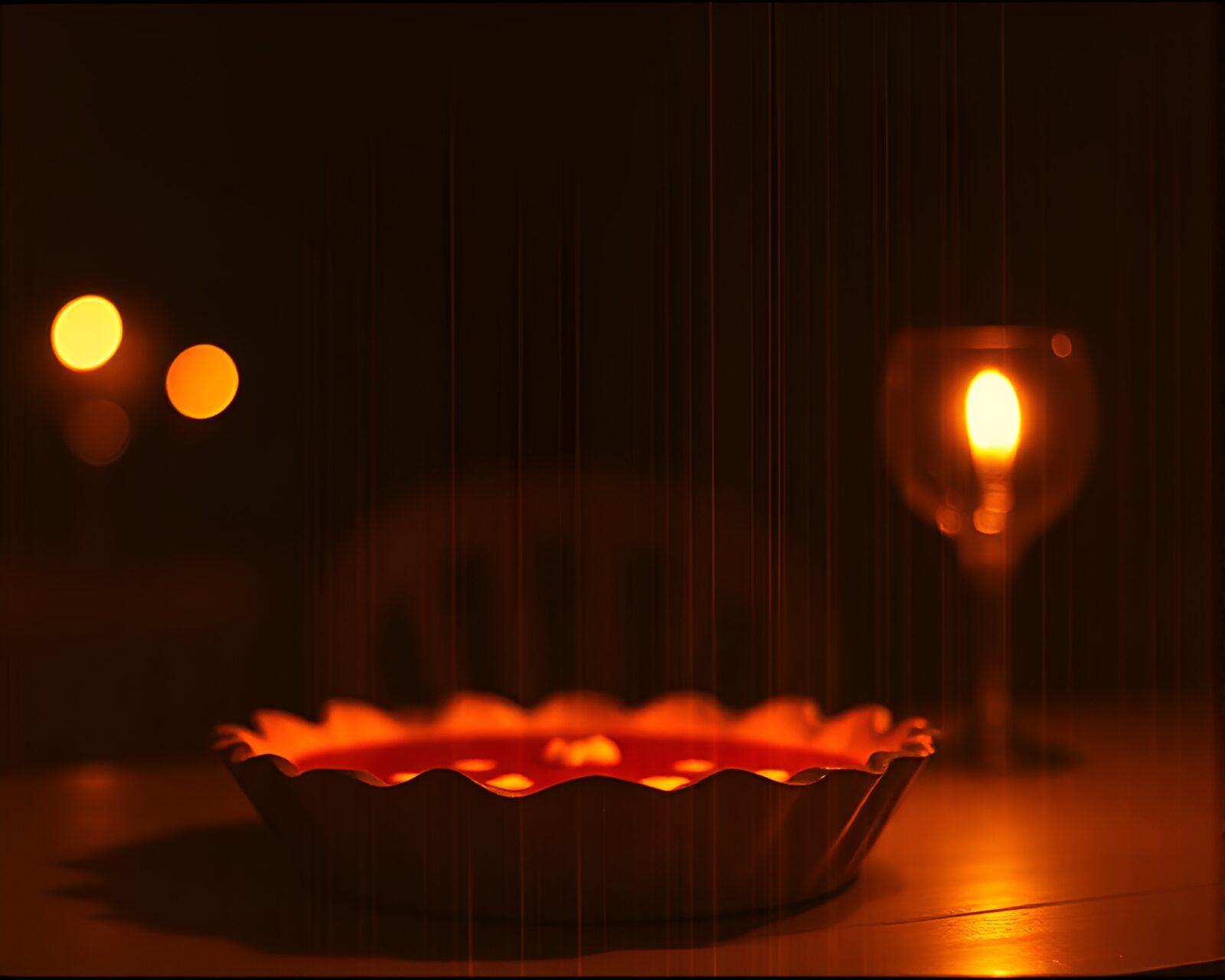 Etched pumpkin pie surrounded by glowing bokeh lights