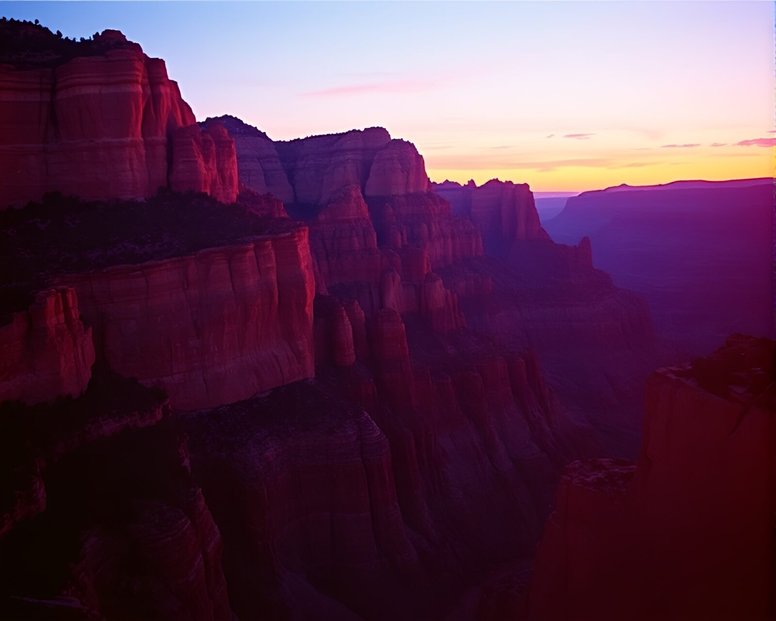 Vibrant canyon with aurora hues and film burns