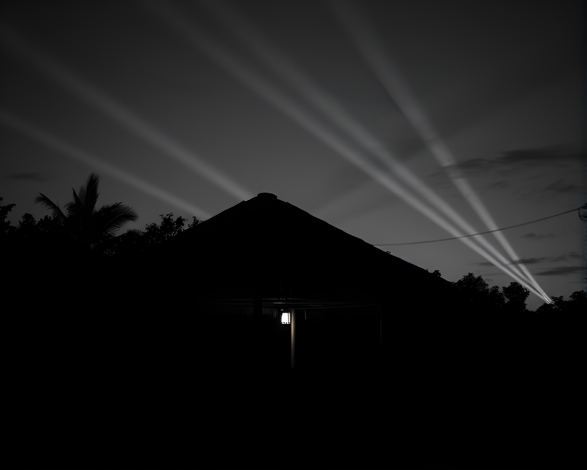 Bamboo Hut Illuminated by Laser Beams at Dusk – free AI stock image