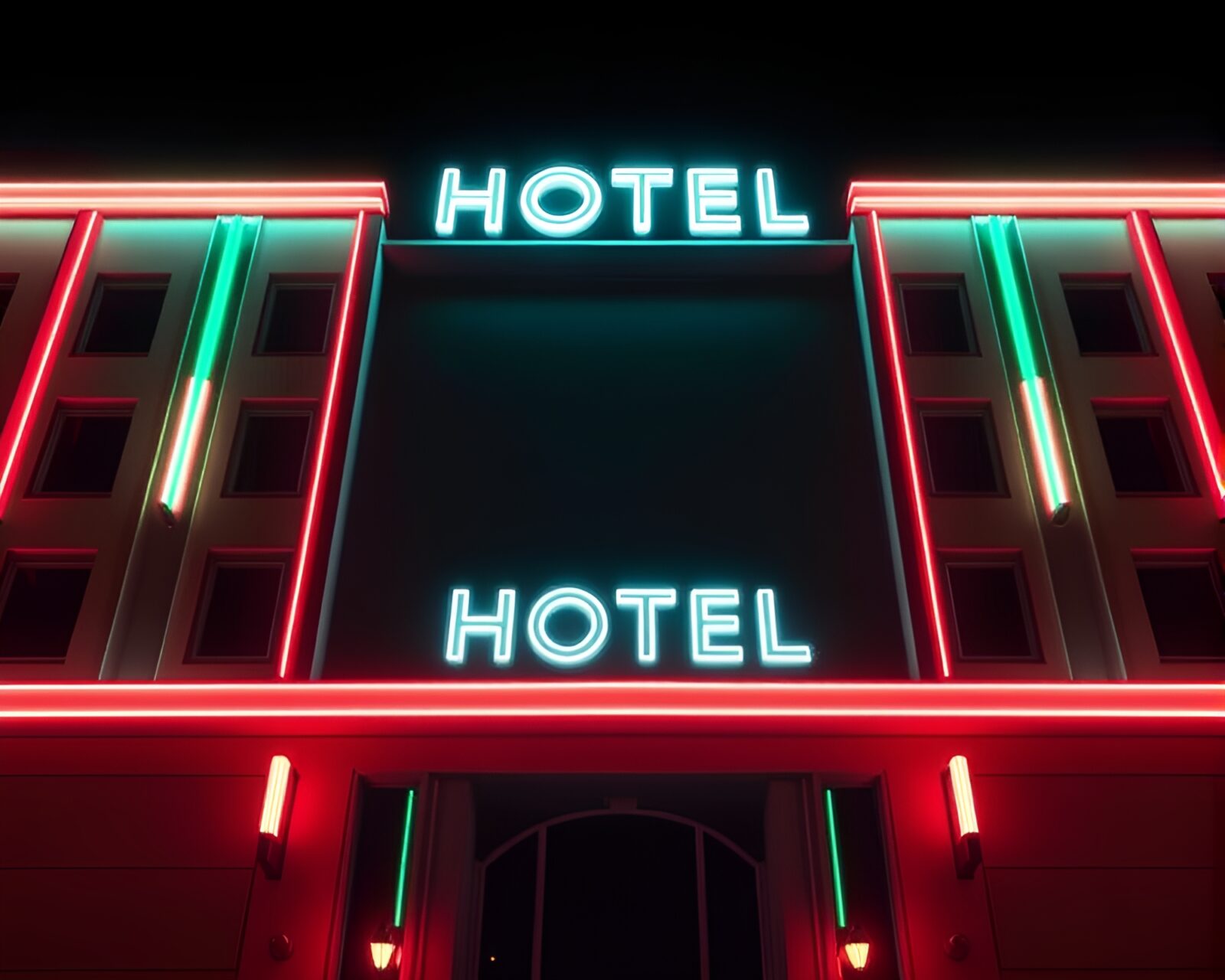 Vibrant neon lights illuminate art deco hotel facade.