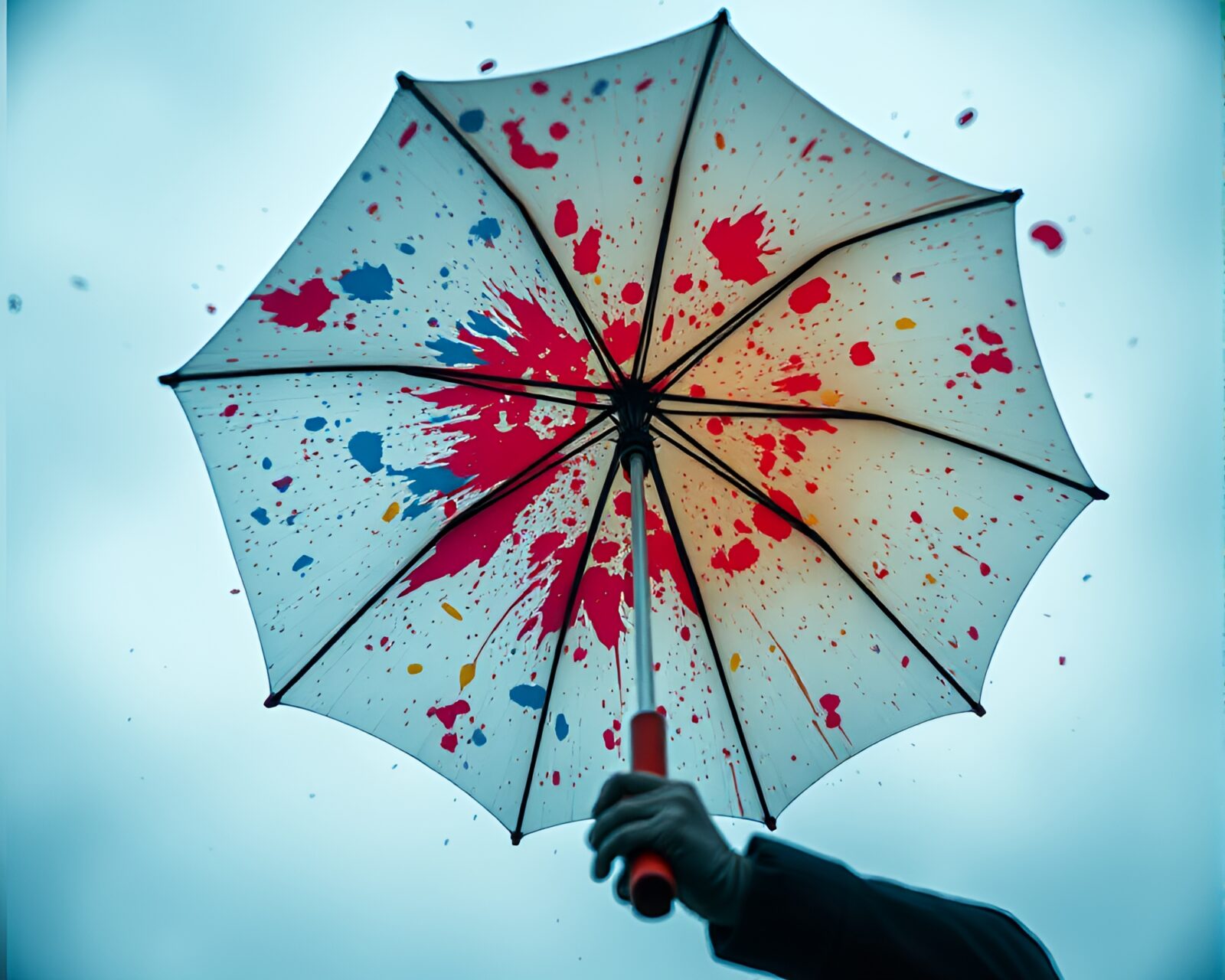 Vivid paint splatter palette scene with overlapping umbrella silhouettes