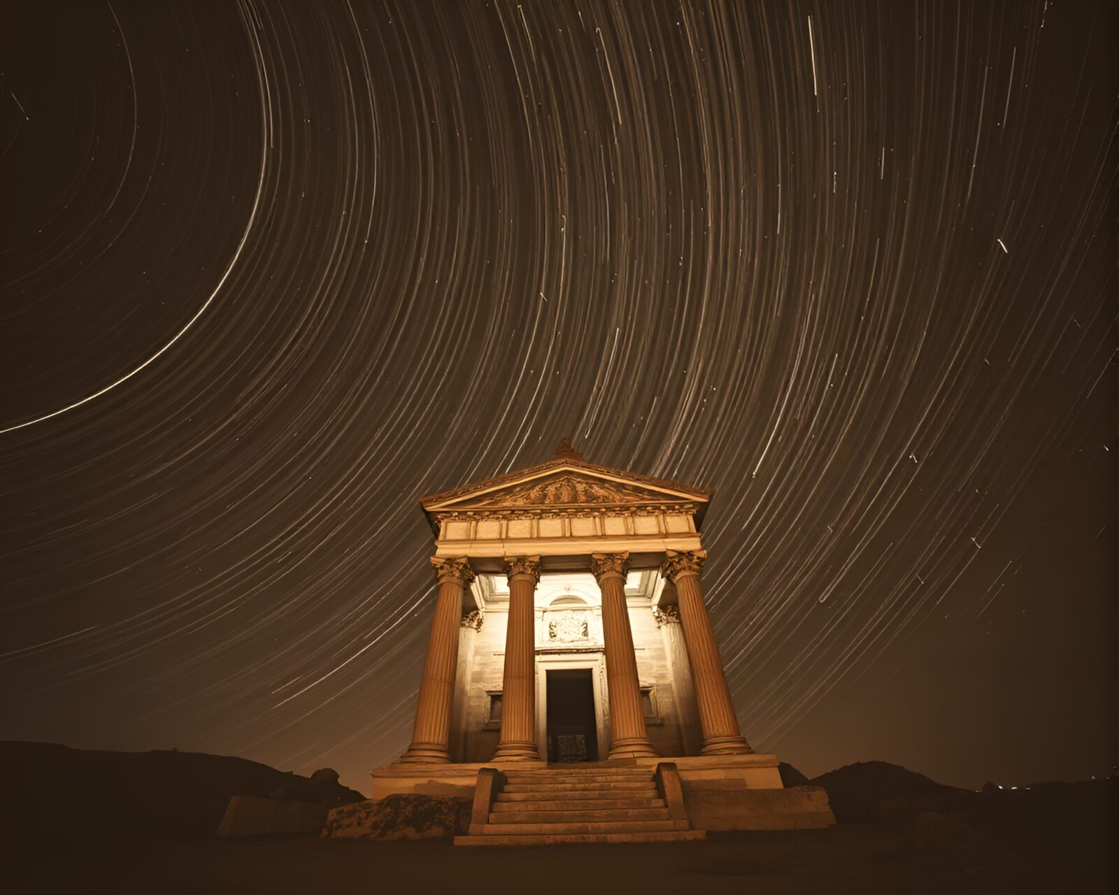 Long exposure light trails around ancient temple at night