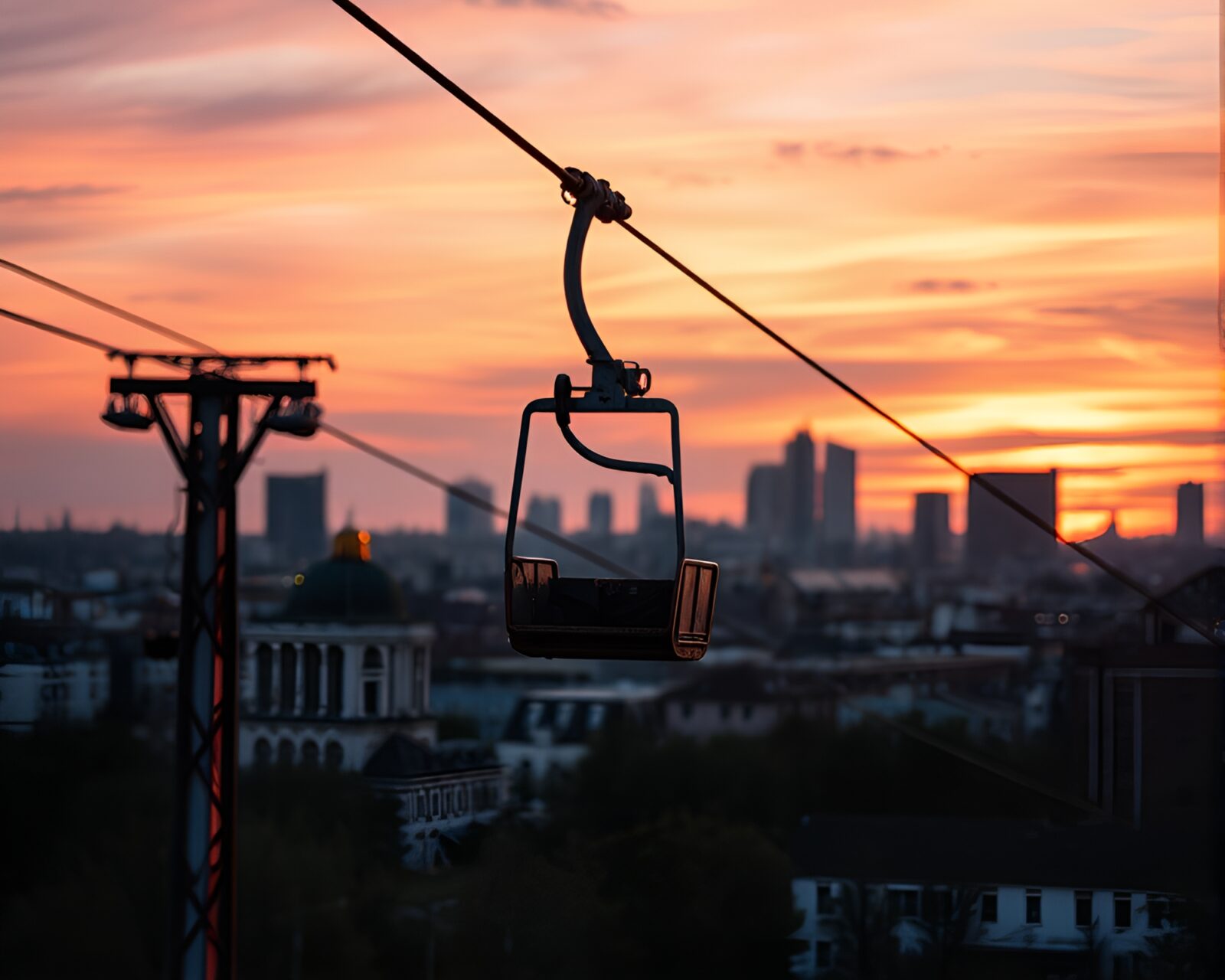 Weathered gondola lift against colorful sunset skyline