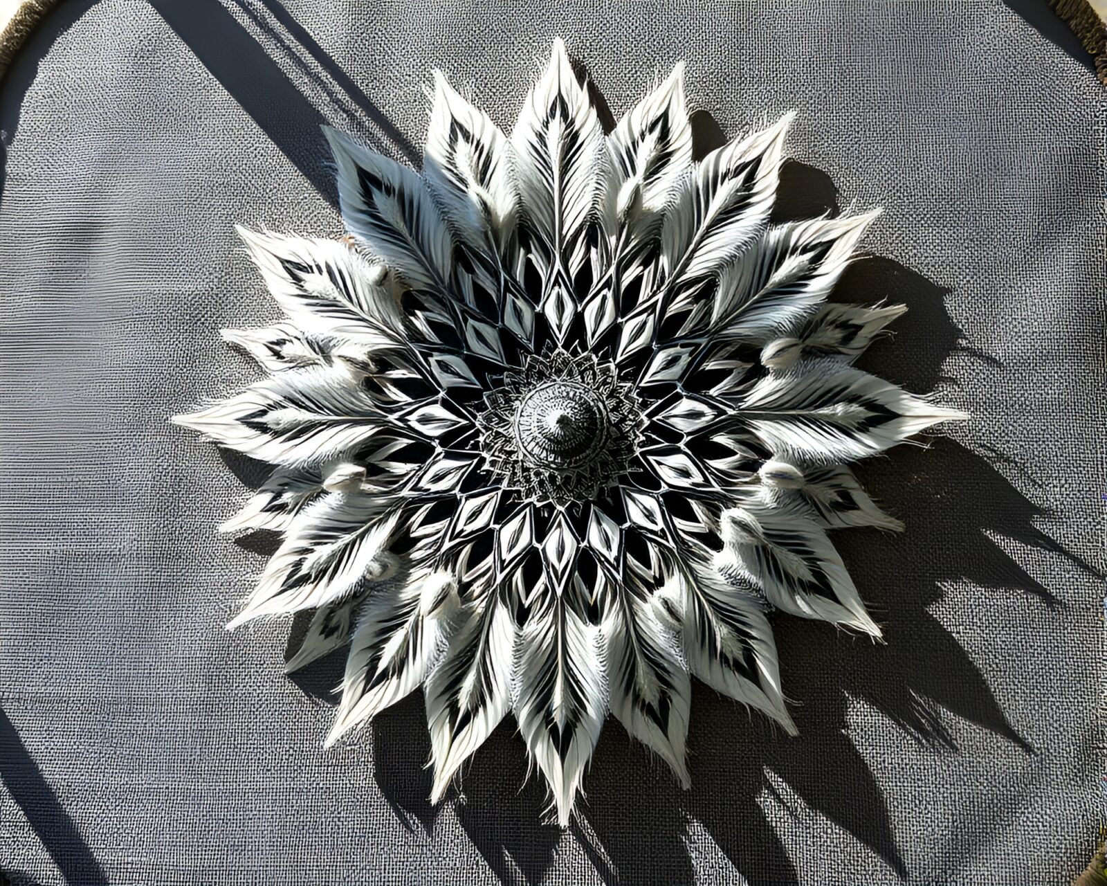 Intricate mandala design being dusted with a feather duster
