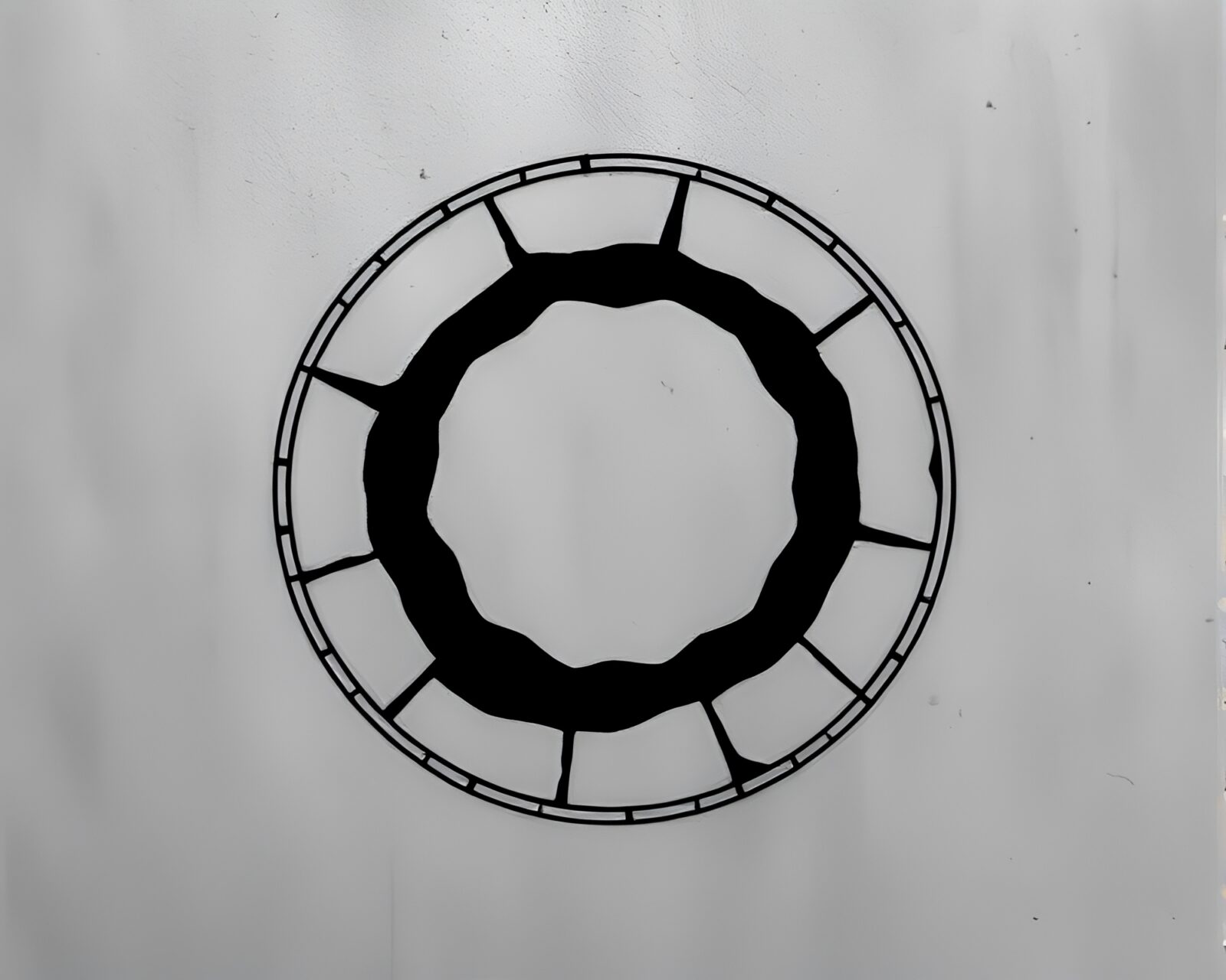 Intricate stitched pattern of stone circle in dark silhouette