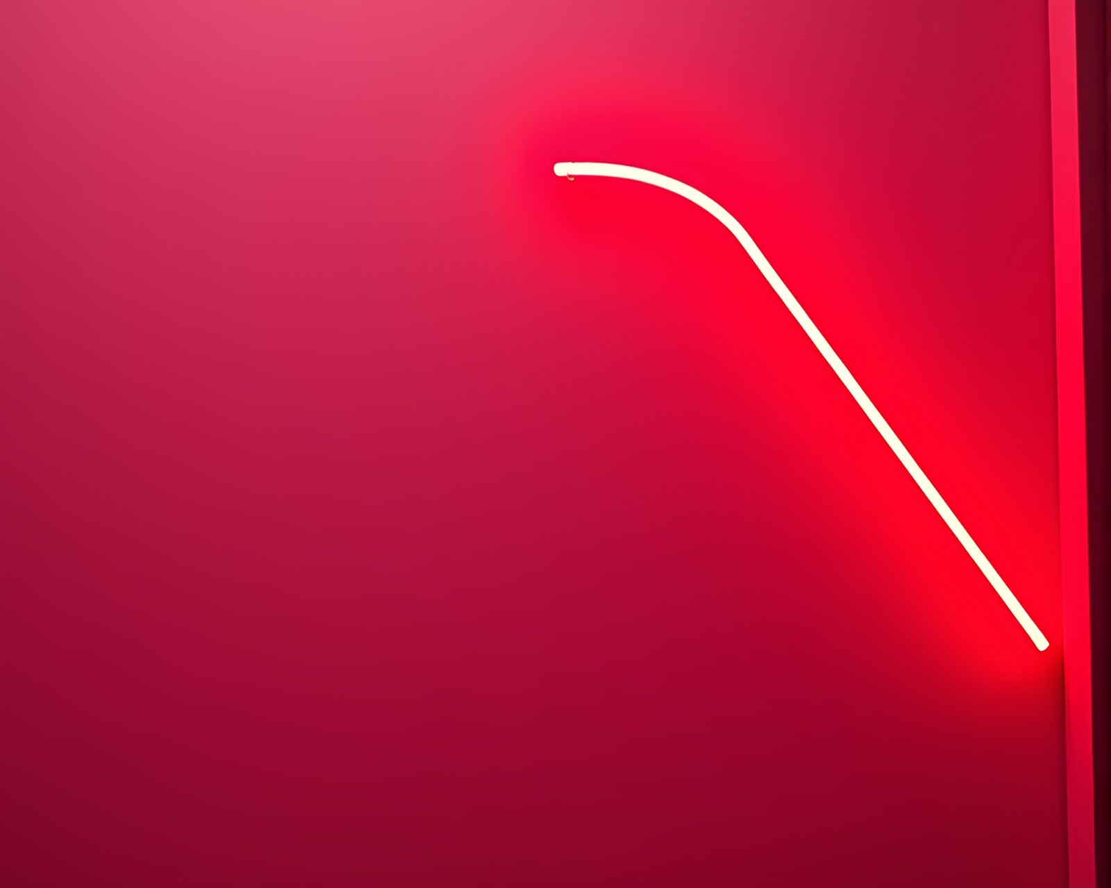 Infrared photography of neon sign with vibrant ruby tones