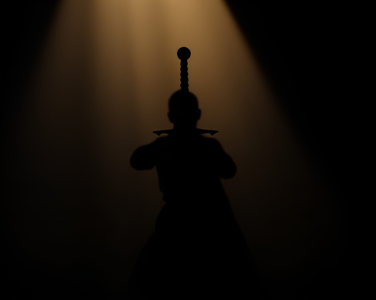 Mysterious figure holding a sword in silhouette against light