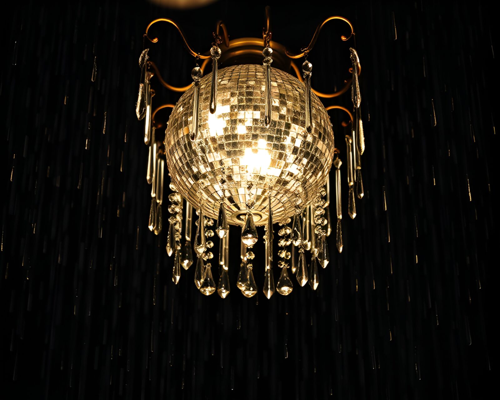 Elegant chandelier with rain droplets reflecting shimmering disco balls