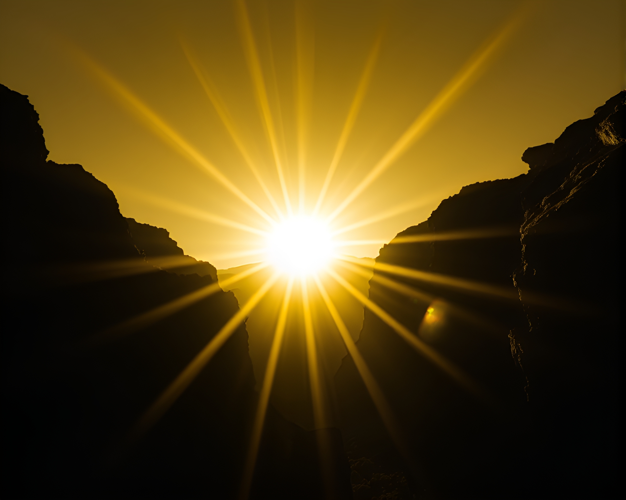 Yellow Monochrome Sunburst over Eroded Canyon Vignette – free AI stock image