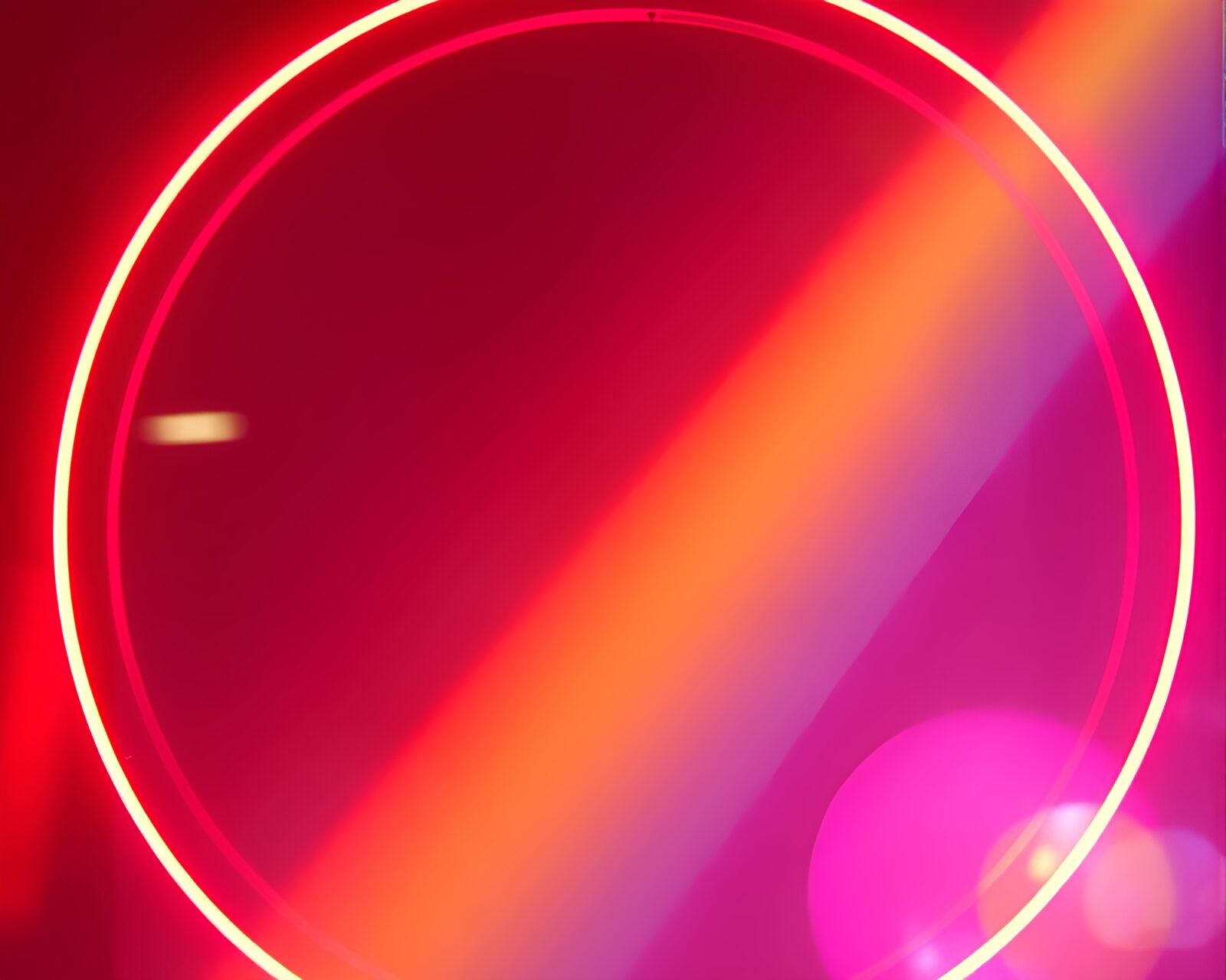 Colorful rainbow light reflecting off neon sign in urban setting