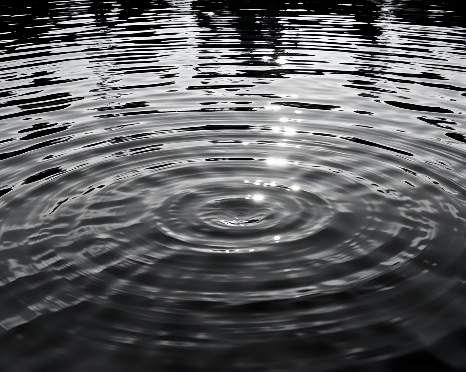 A captivating duochrome image of binary code reflected on rippling water under god rays