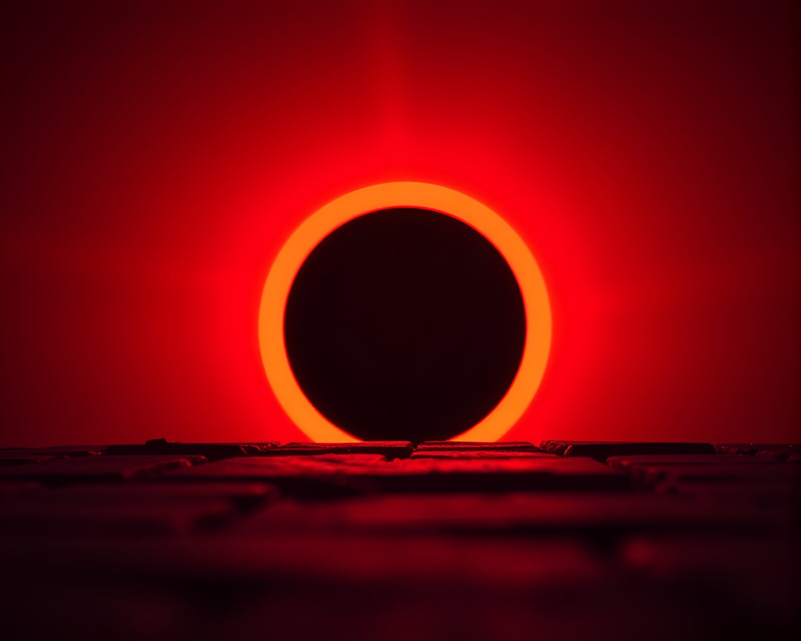 Close-up of solar eclipse with red tinted lighting